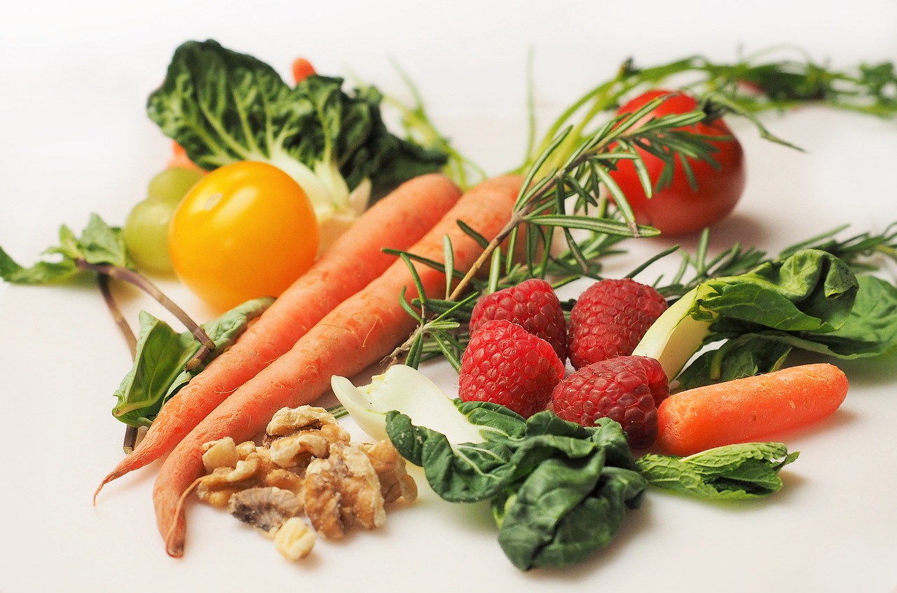 Image of produce (carrots, berries, green leafy vegetables, tomatoes, and nuts)