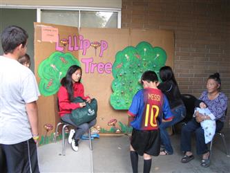 students standing in front of lollipop tree display.